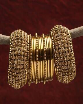 11166b_2.8 set of 17 gold-plated stone-studded bangles