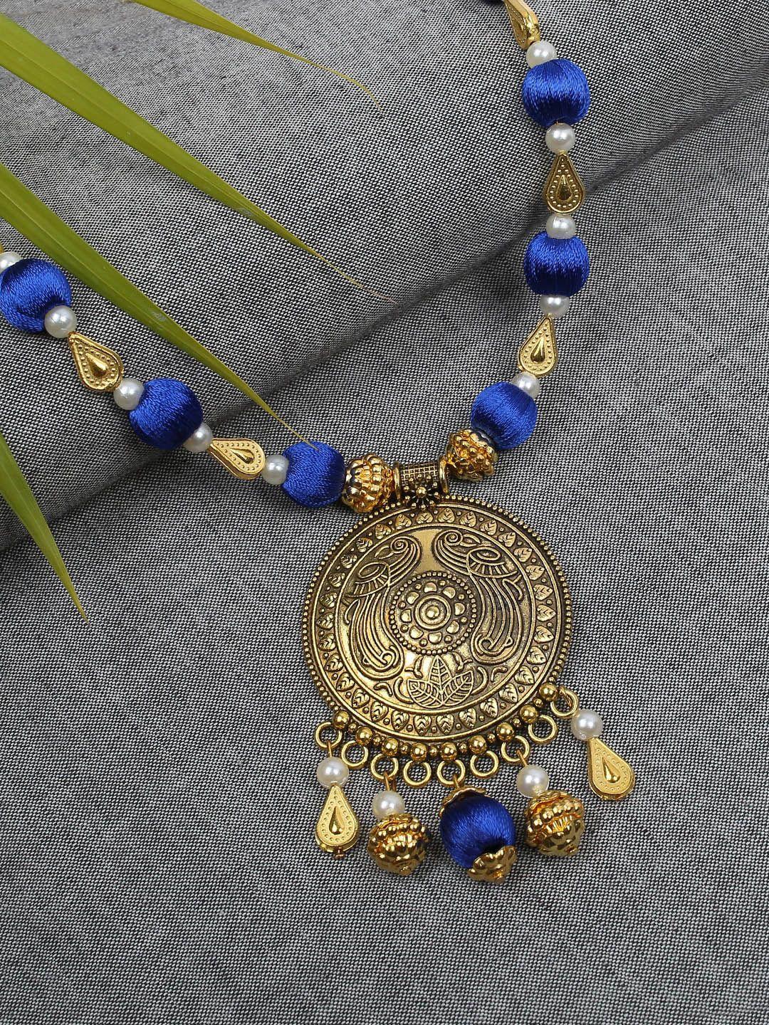 akshara gold-toned & blue handcrafted long brass pendent necklace