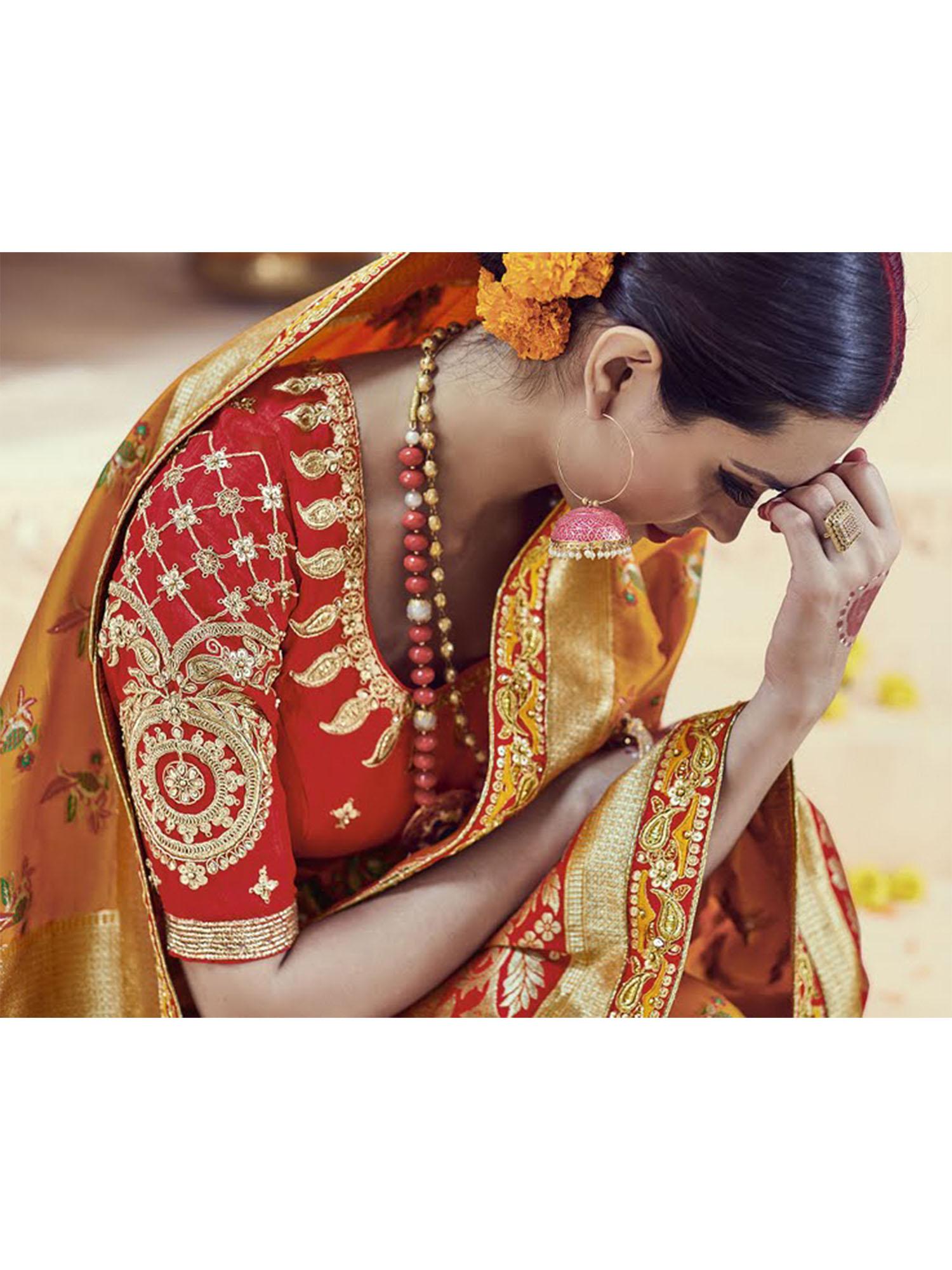 amber colored embroidered kanjipuram silk saree with un-stitched blouse