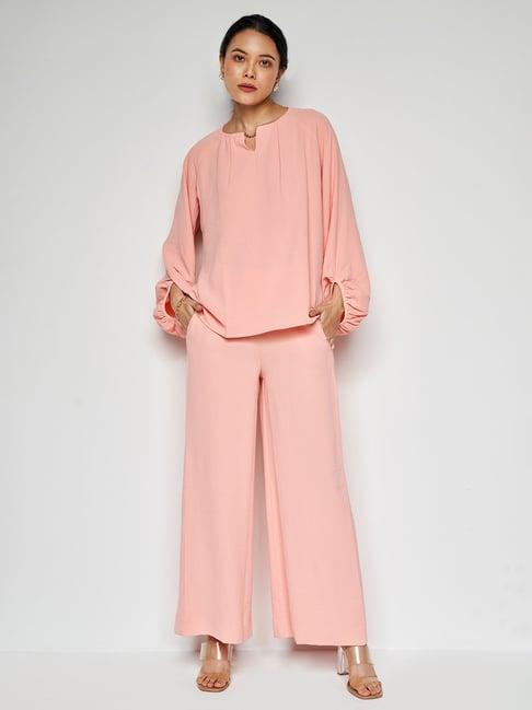 and peach top with palazzos