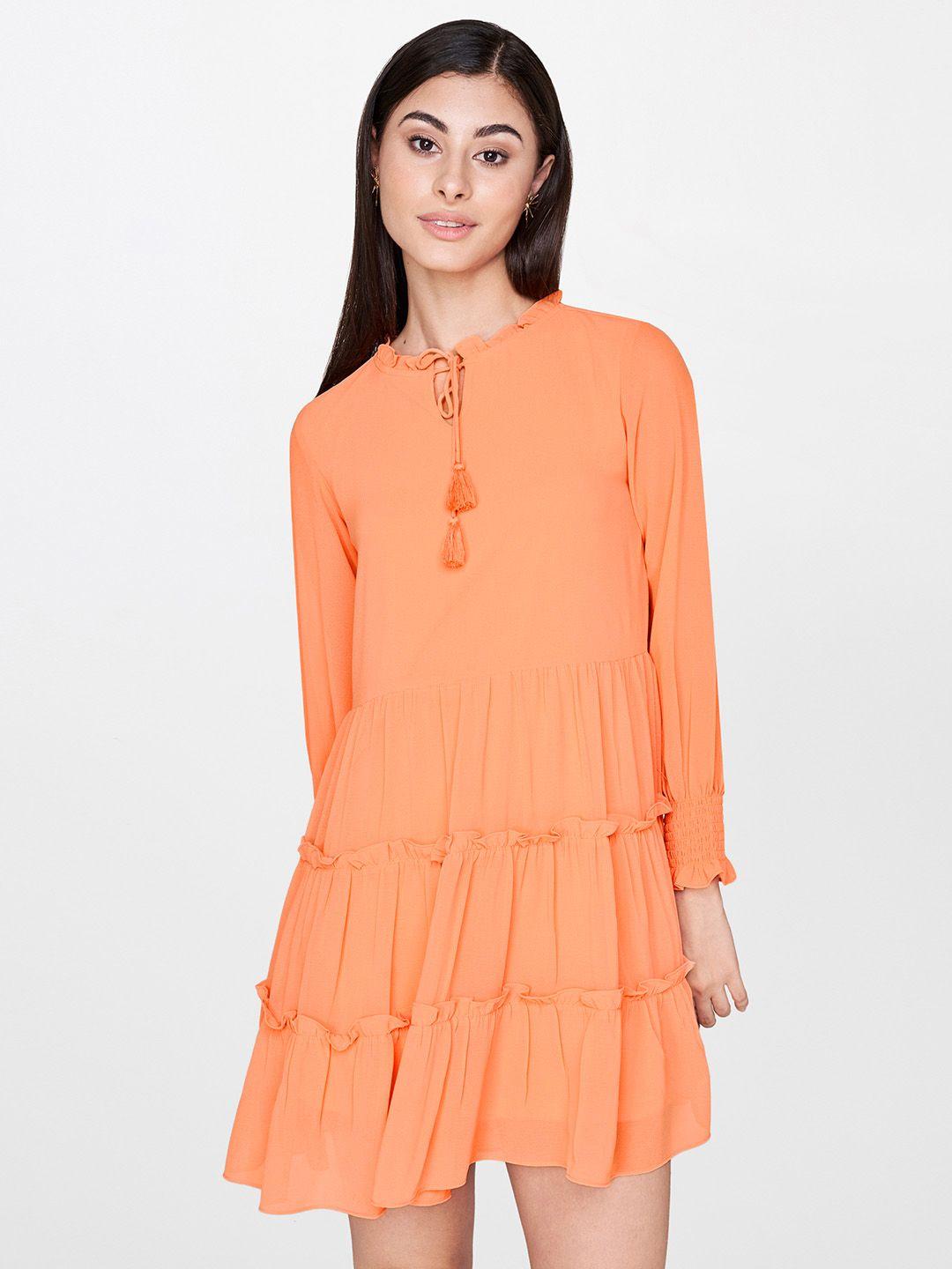 and women peach-coloured solid fit and flare dress with ruffle detail