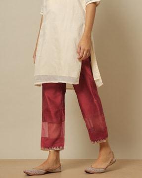 ankle-length pants with embroidered hems