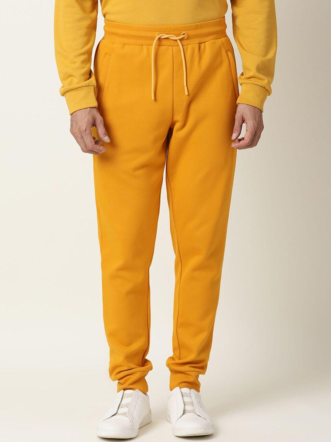 articale men mustard solid slim-fit track pants