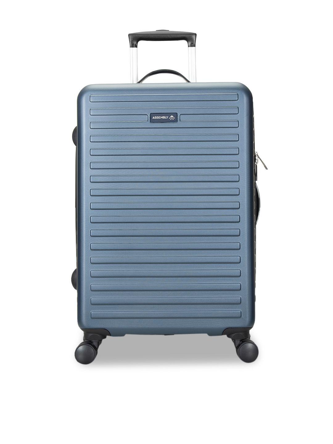 assembly blue textured medium hard luggage trolley bag