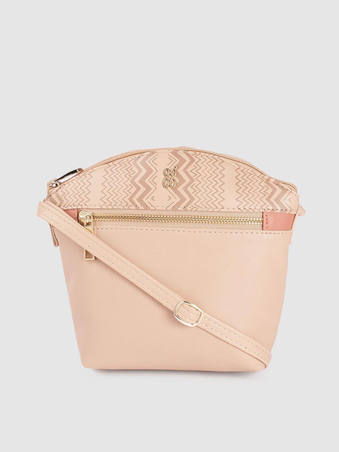baggit nude-coloured solid structured regular sling bag with minimal chevron print detail