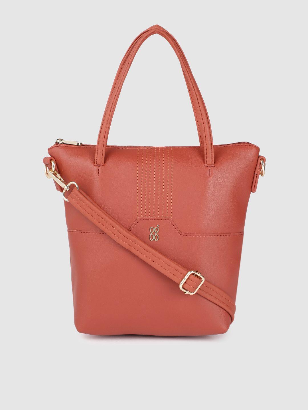 baggit rust orange solid structured handheld bag