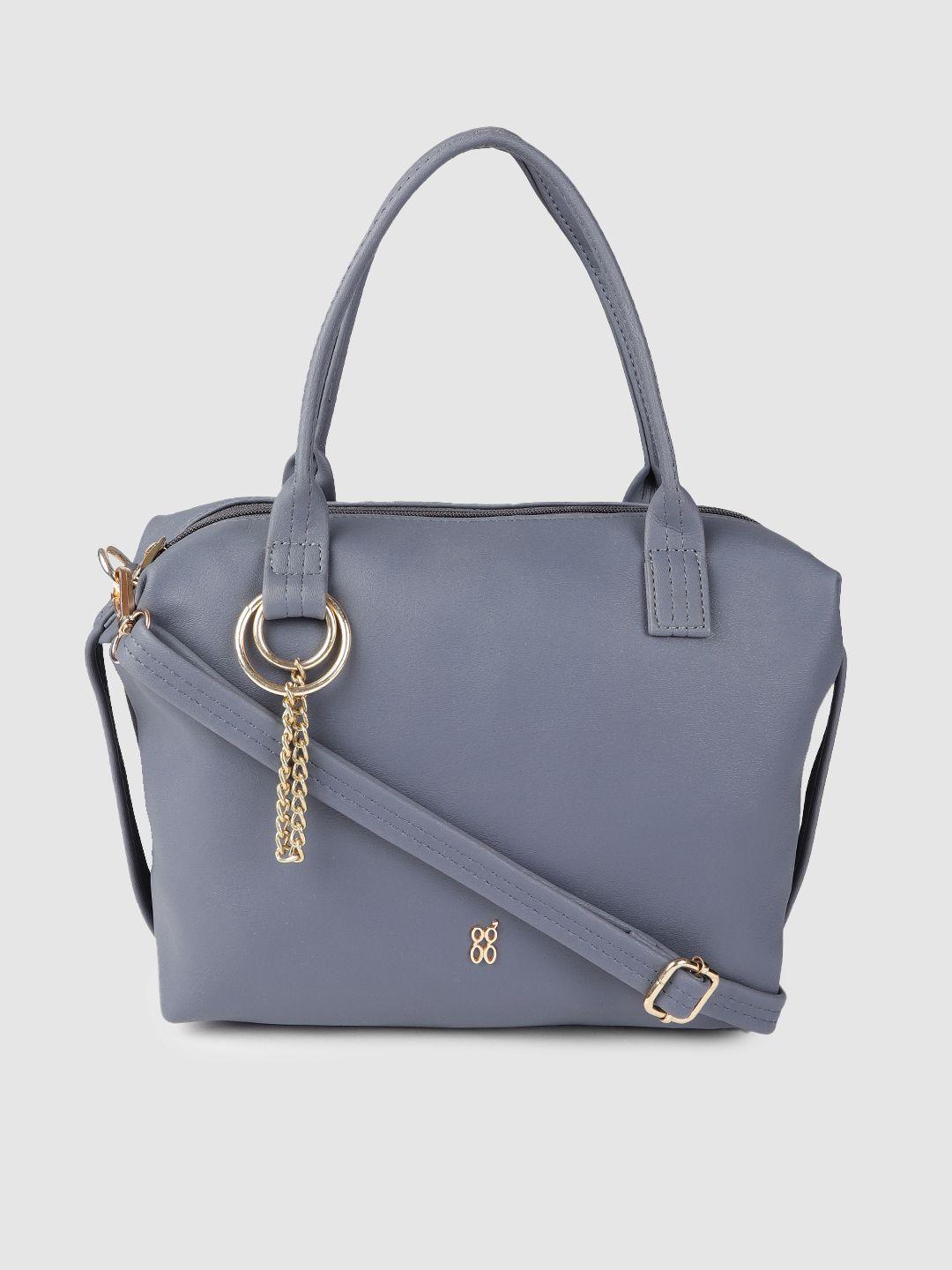 baggit vintage blue solid regular structured handheld bag with tasselled detail
