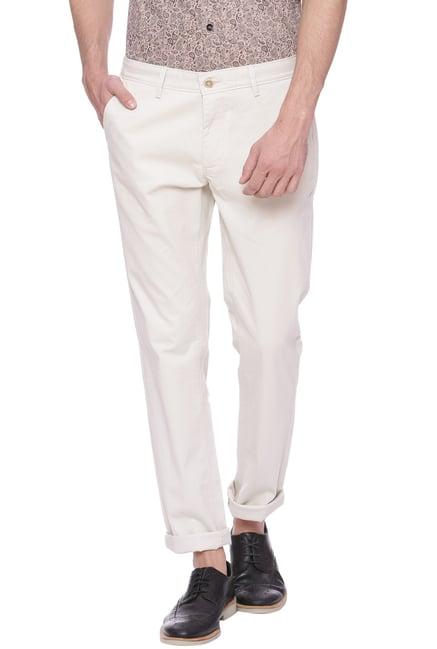 basics ecru tapered fit solid trousers