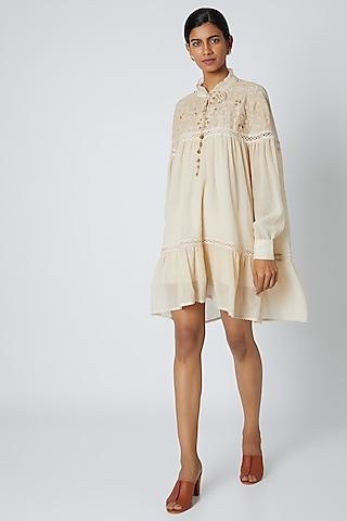 beige embroidered dress with tassels