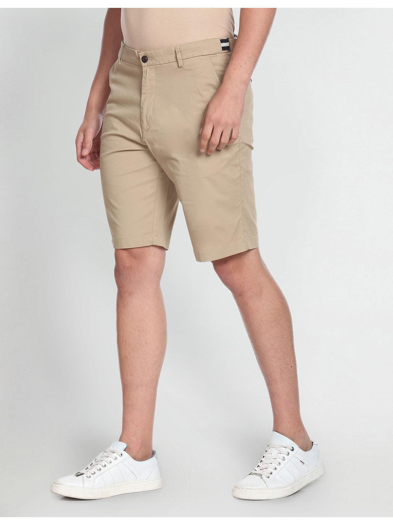 beige mid rise autoflex solid shorts
