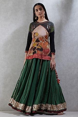 black embroidered top with green skirt