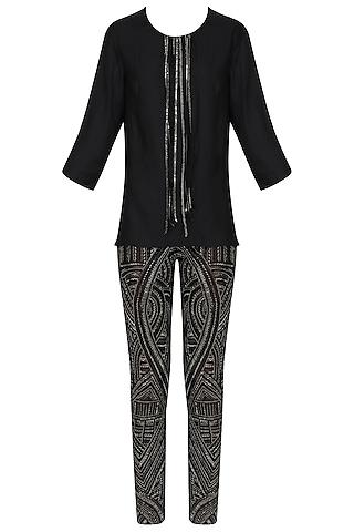 black tasseled top with embroidered pants