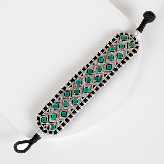 black chord and emerald bracelet
