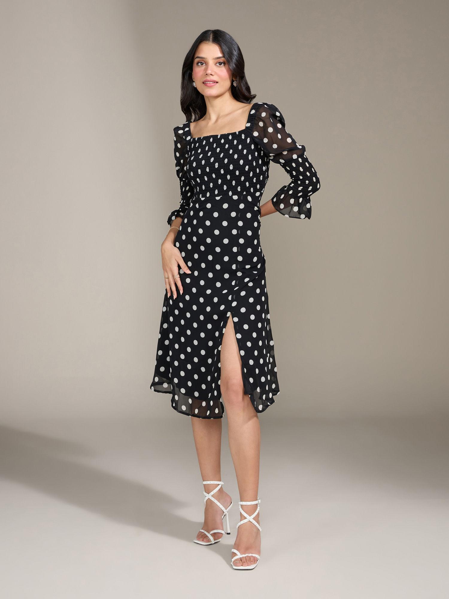 black slipping into polka midi dress