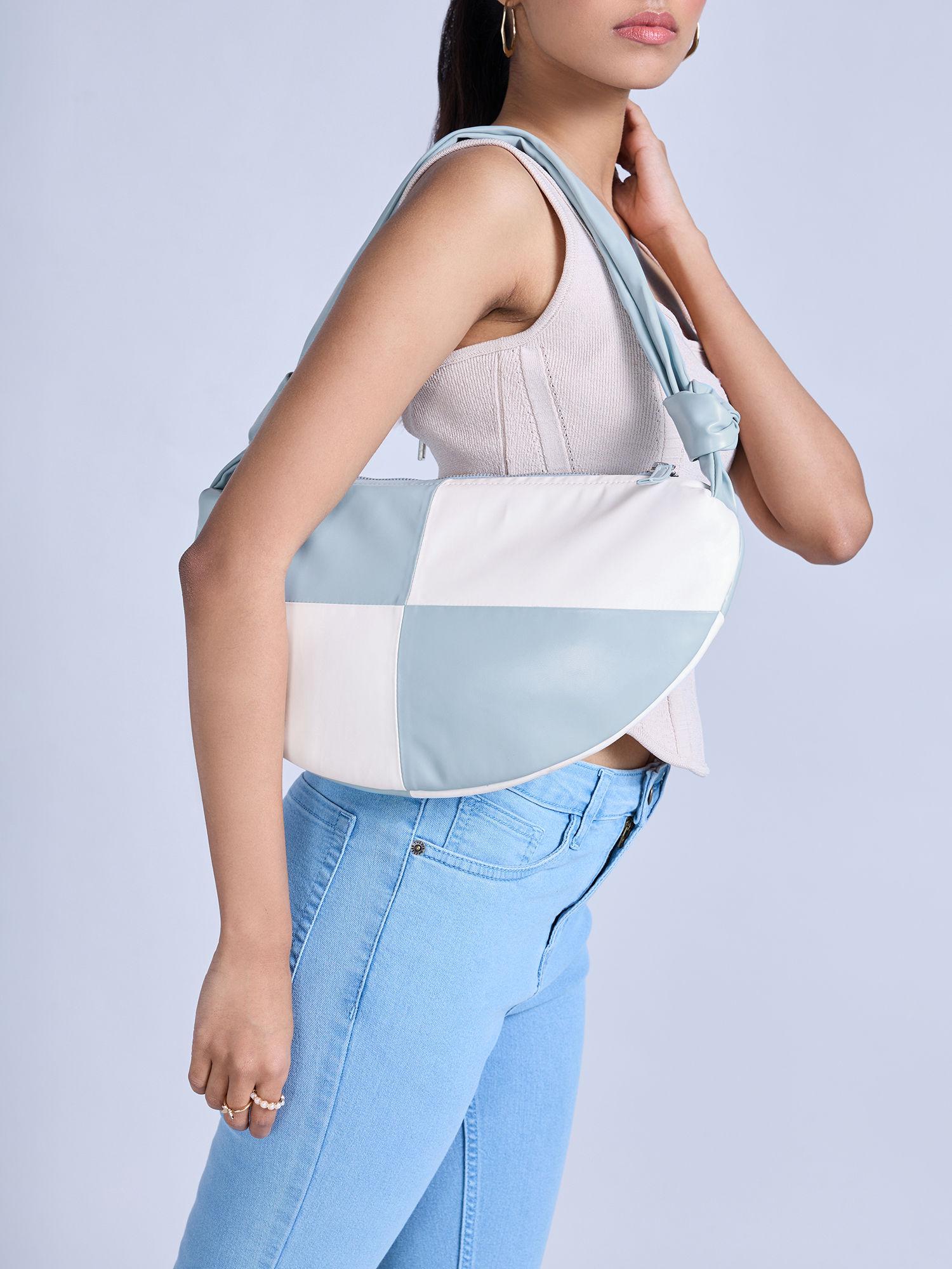 blue and white semi circular colorblock bag