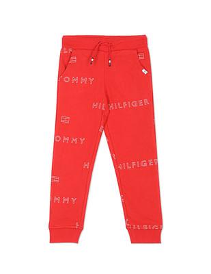 boys red mid rise all over logo print joggers