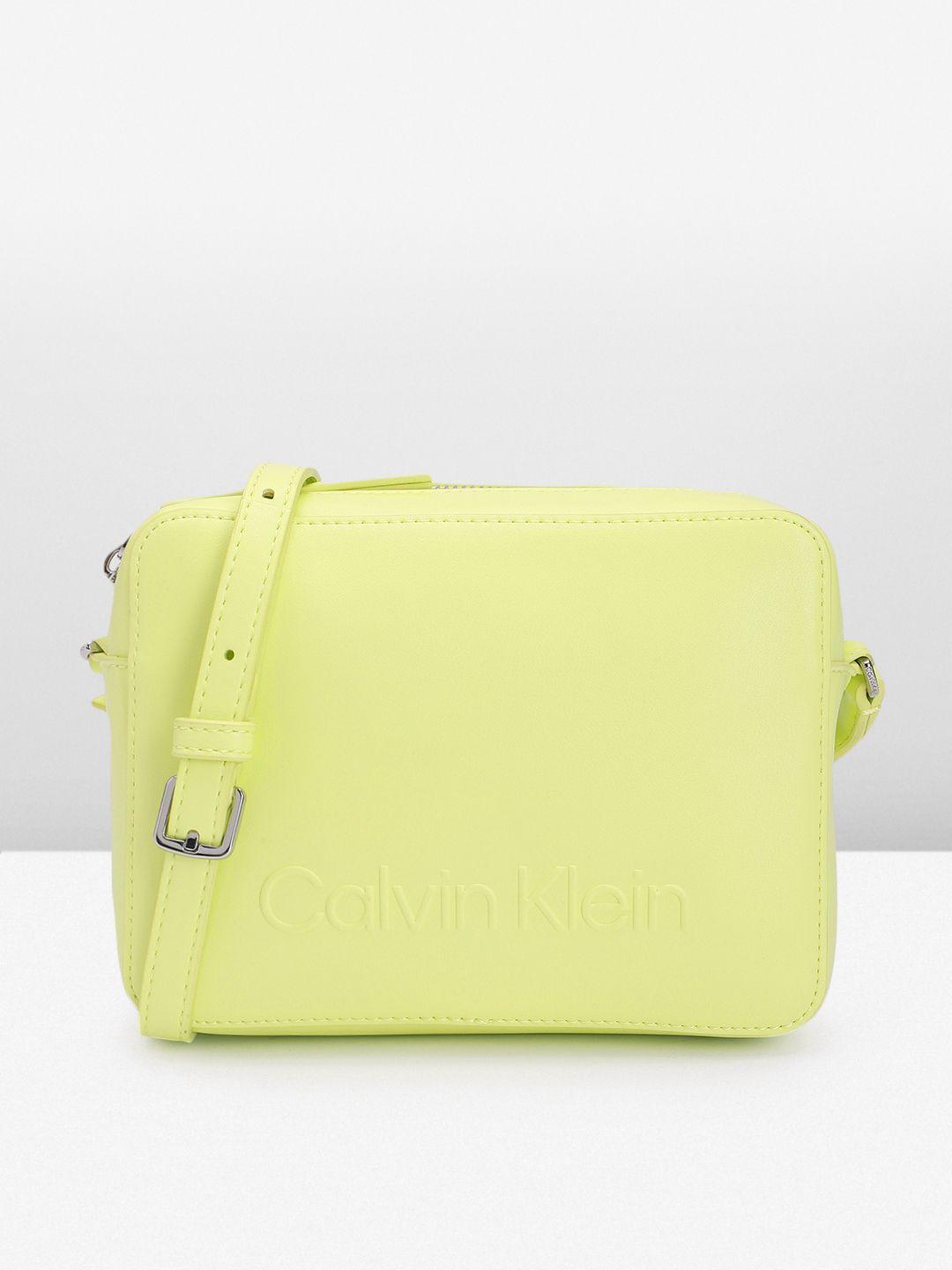 calvin klein solid pu structured sling bag with brand logo embossed detail & a cover pouch