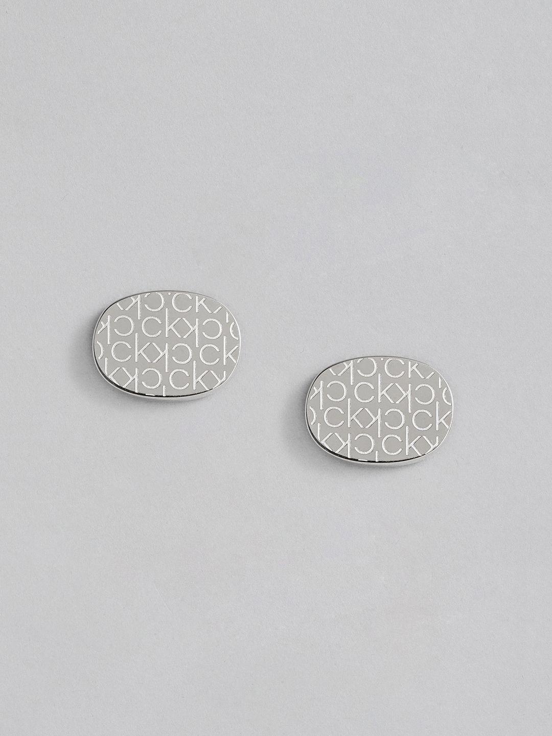 calvin klein brand logo print brass plated stainless steel oval shaped studs