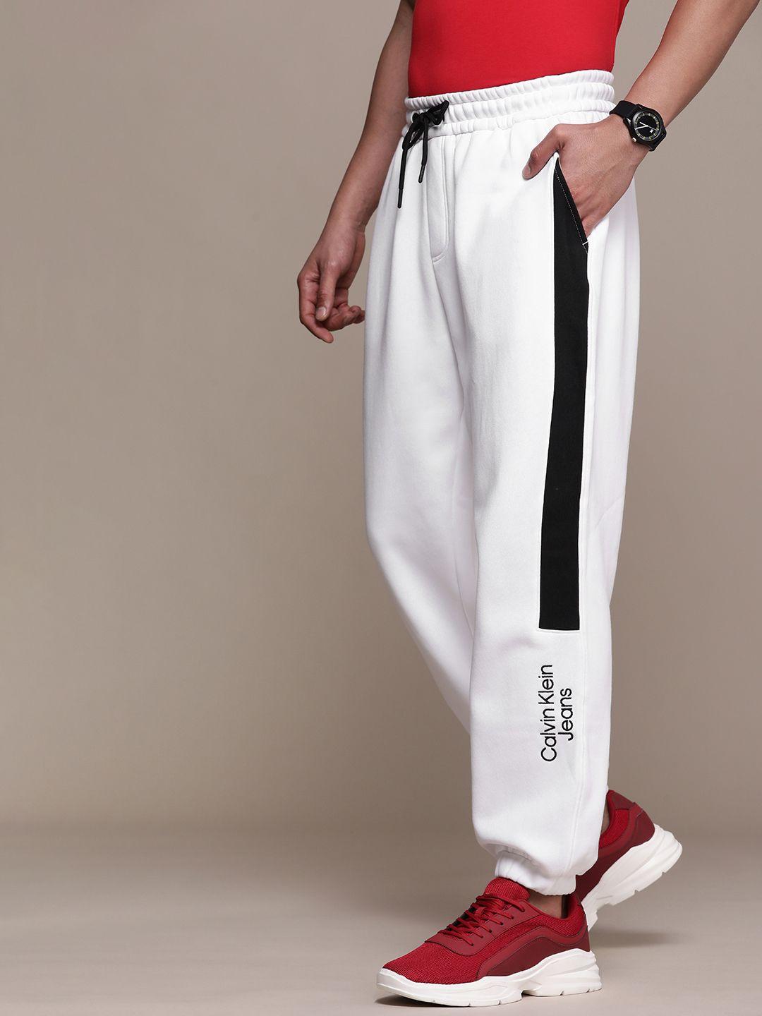 calvin klein jeans white  brand logo printed mid rise joggers with constrast side stripes