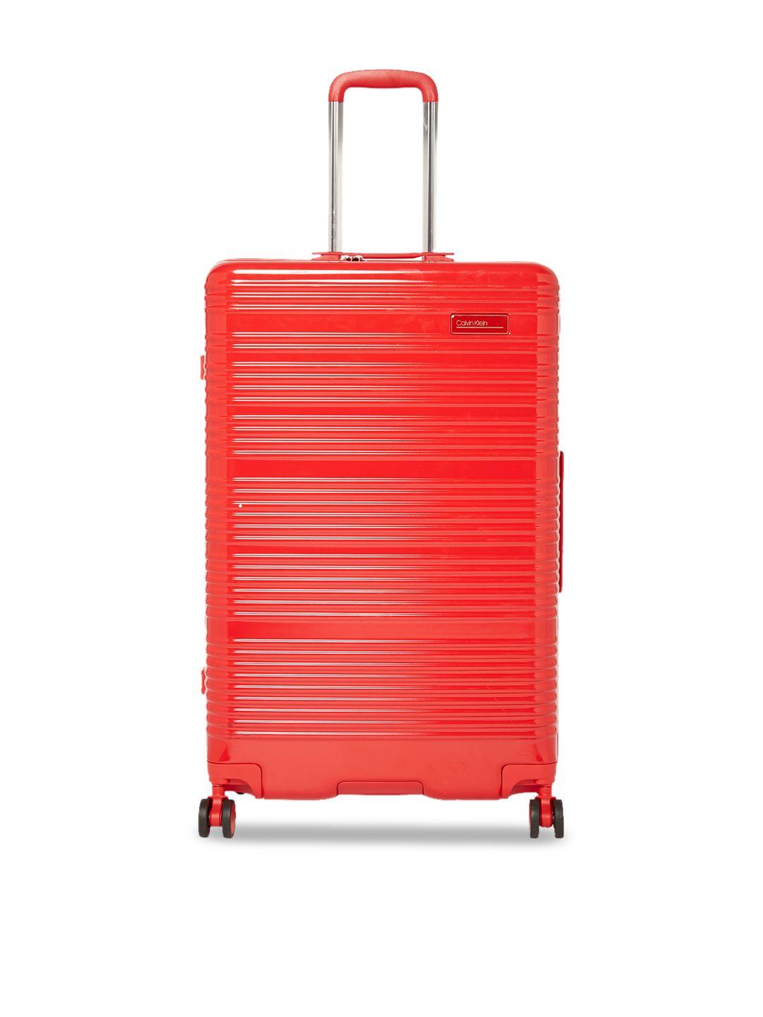 calvin klein red textured globetrotter hard-sided large trolley suitcase