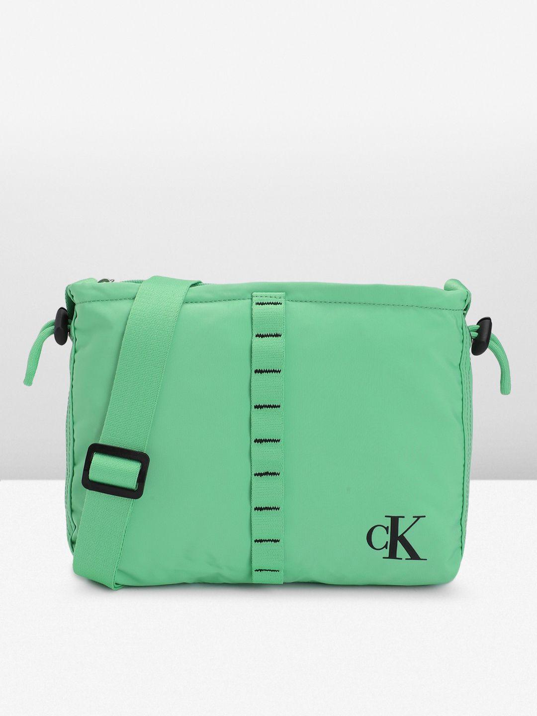 calvin klein solid structured sling bag with cinched applique detail & toggle