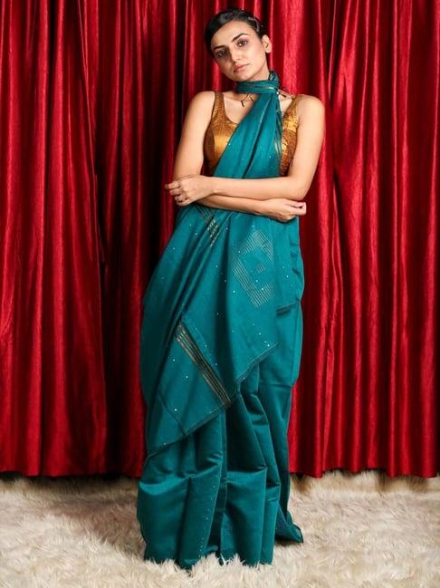 charukriti teal blue embellished saree with unstitched blouse