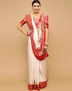 checked saree with contrast border and tassels