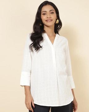 checked tunic with curved hem