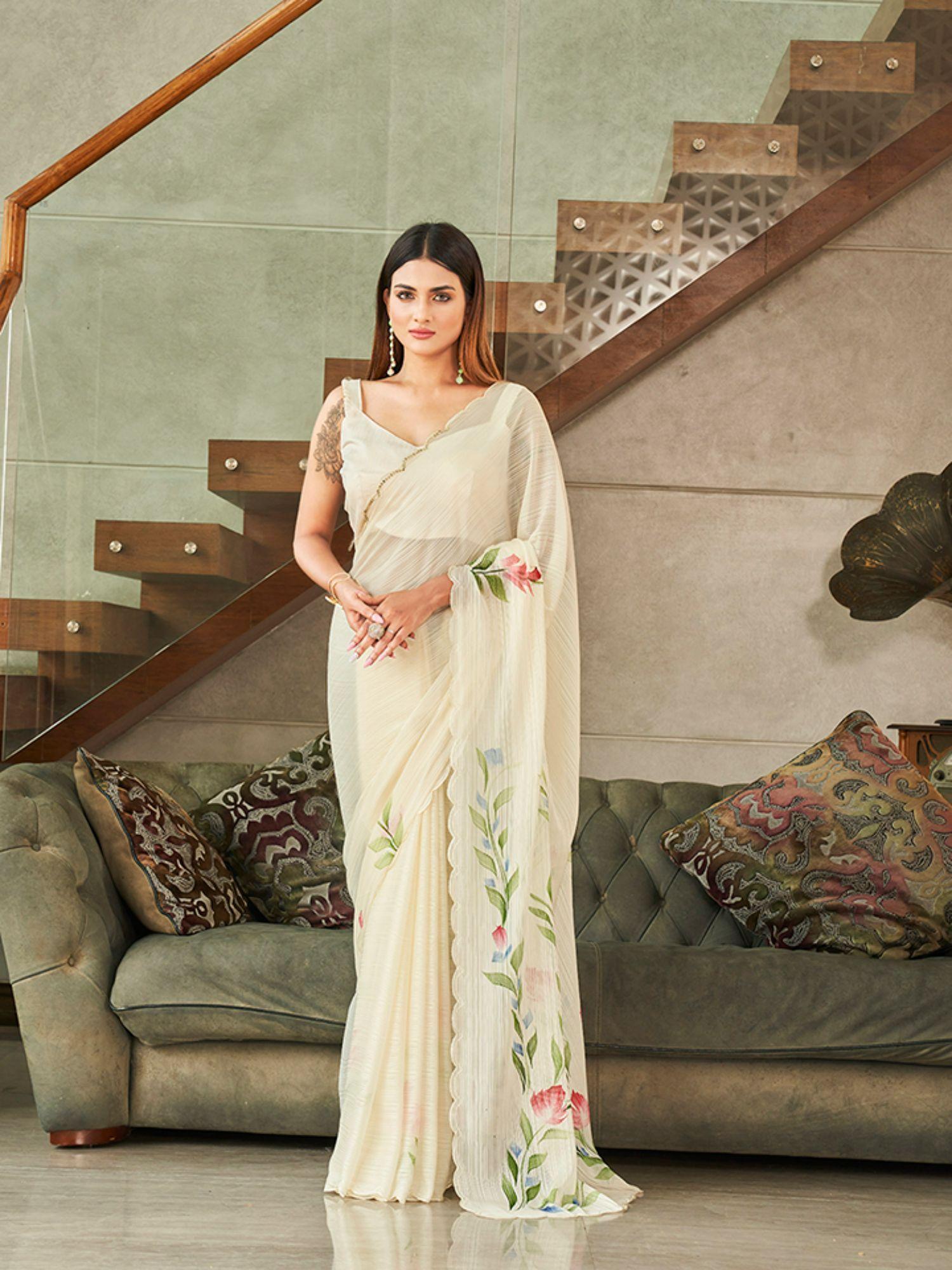 cream colored polyester saree with hand print and scalloped border with unstitched blouse