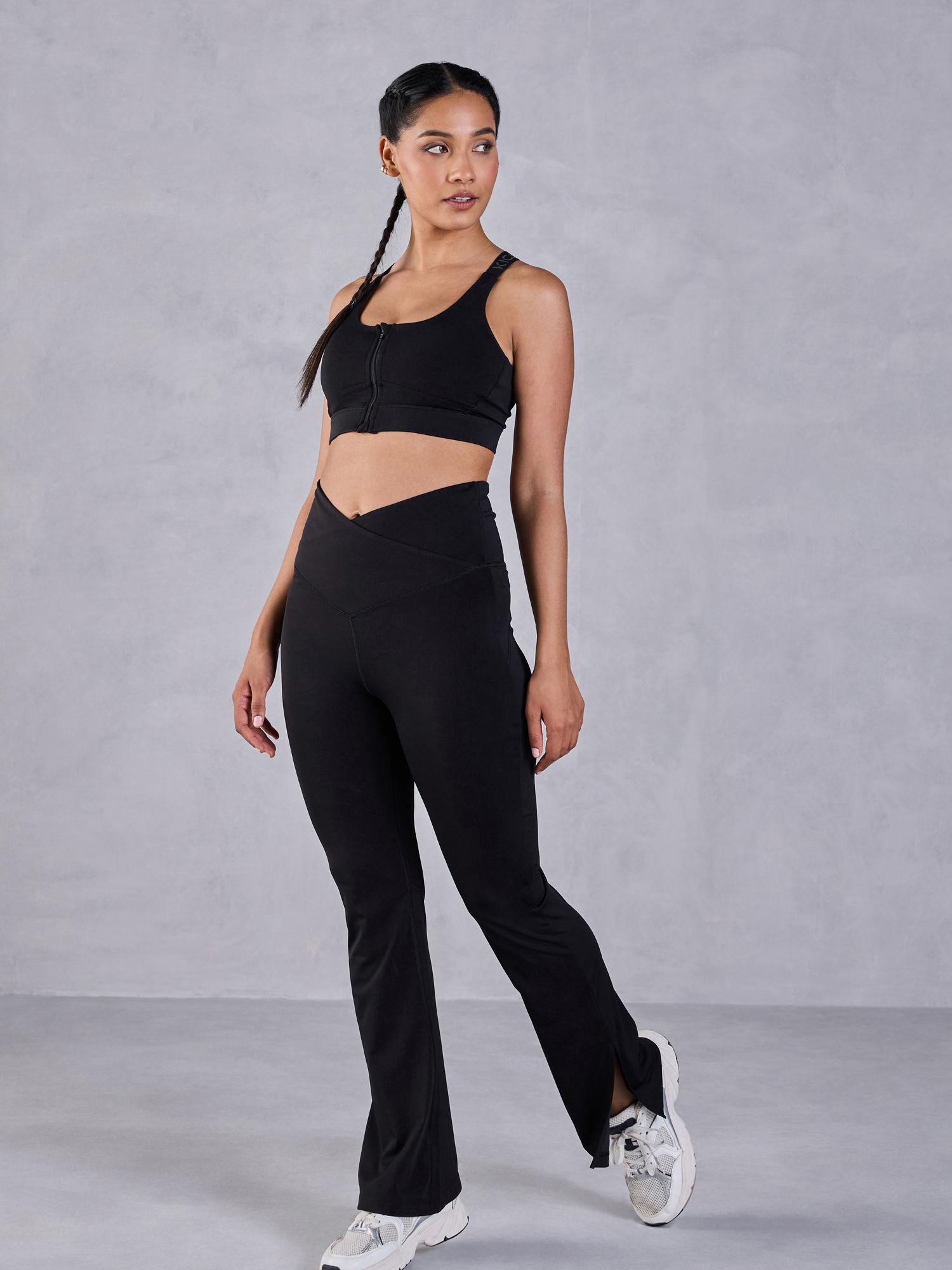 criss-cross flare pants in second skn with a mid-rise waistband and side slits