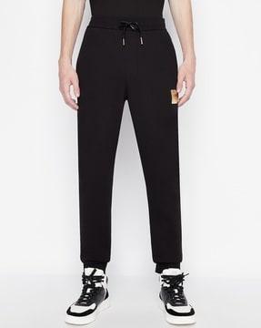 cuffed track pants with logo patch