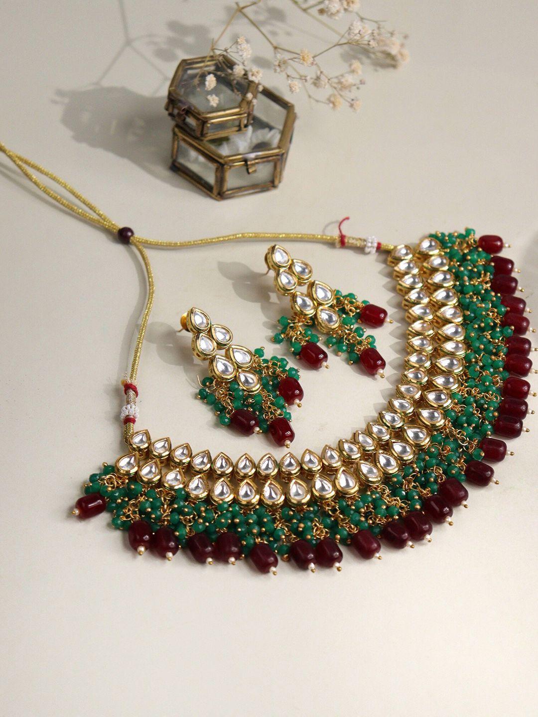 curio cottage gold-plated kundan-studded & pearl beaded jewellery set