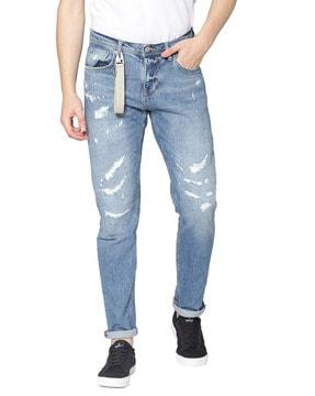 distressed full length tapered jeans