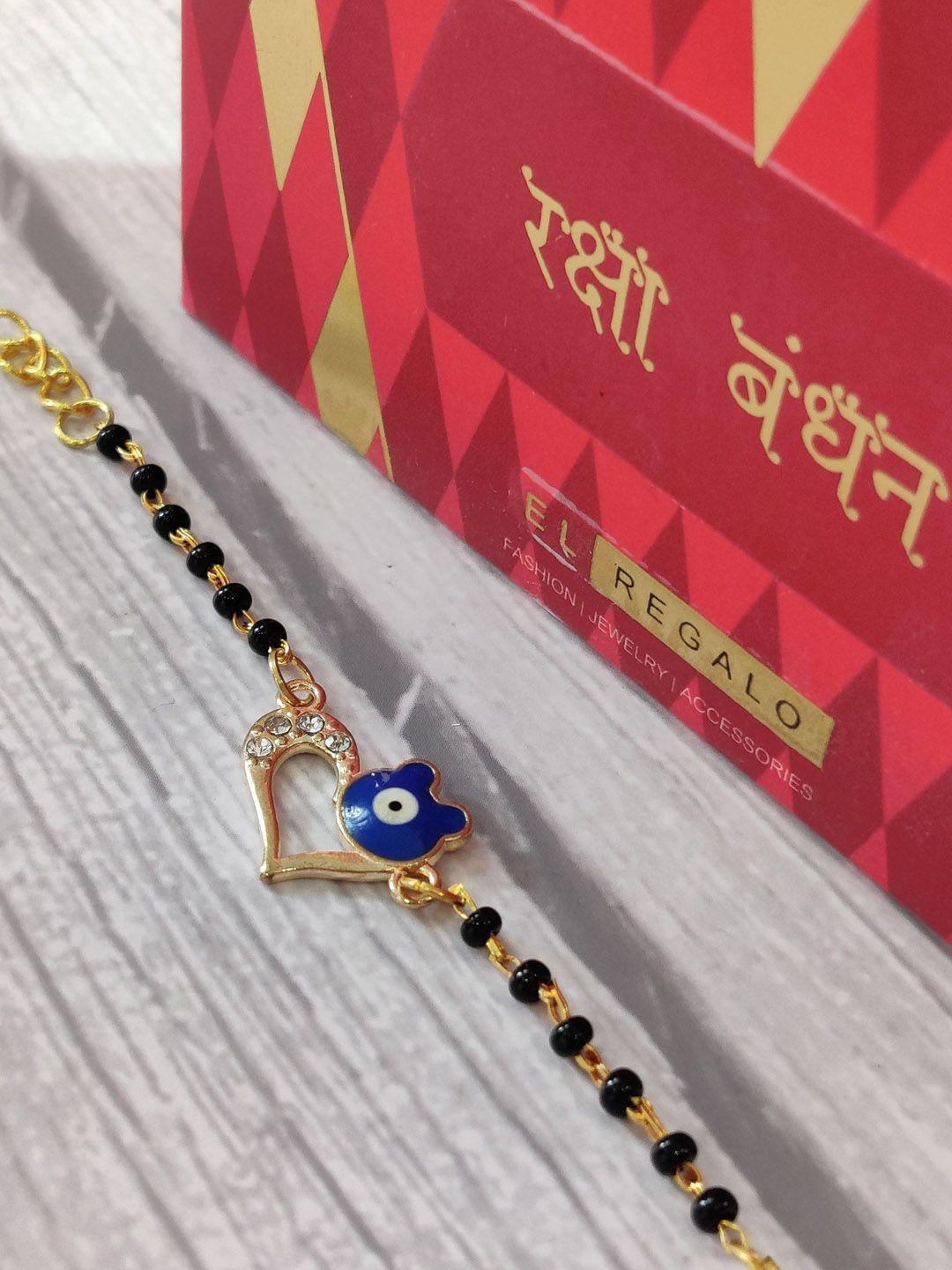 el regalo gold coloured & blue evil eye wrap around rakhi with roli chawal & raksha bandhan greeting card