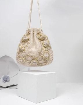 embellished sling bag with drawstring closure