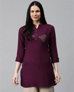 embellished tunic with curved hemline