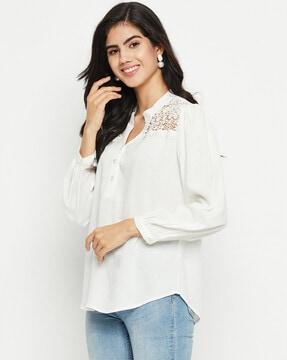 embroidered button-down top with curved hem