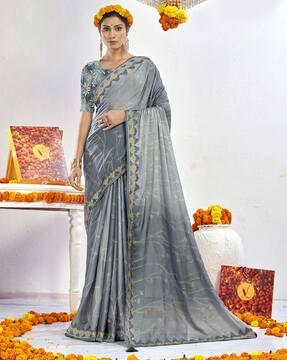 embroidered saree with contrast border & tassels