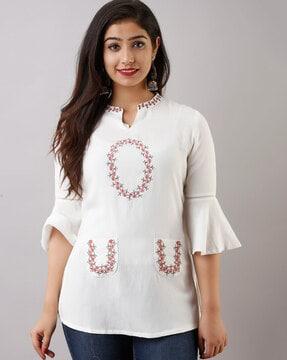 embroidered top with patch pockets