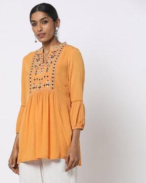 embroidered tunic with puff sleeves