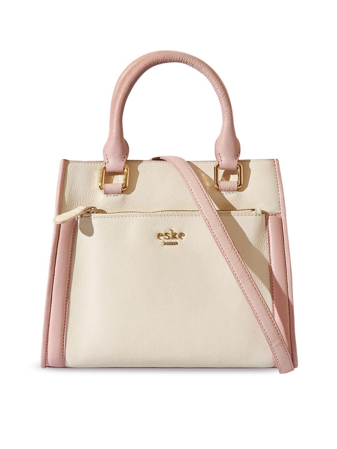 eske peach-coloured leather structured handheld bag with tasselled