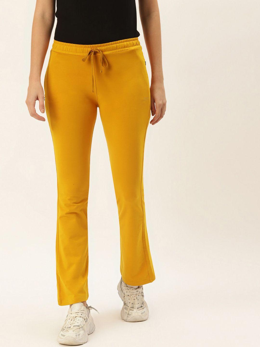 femea women mustard yellow solid bootcut fit track pants