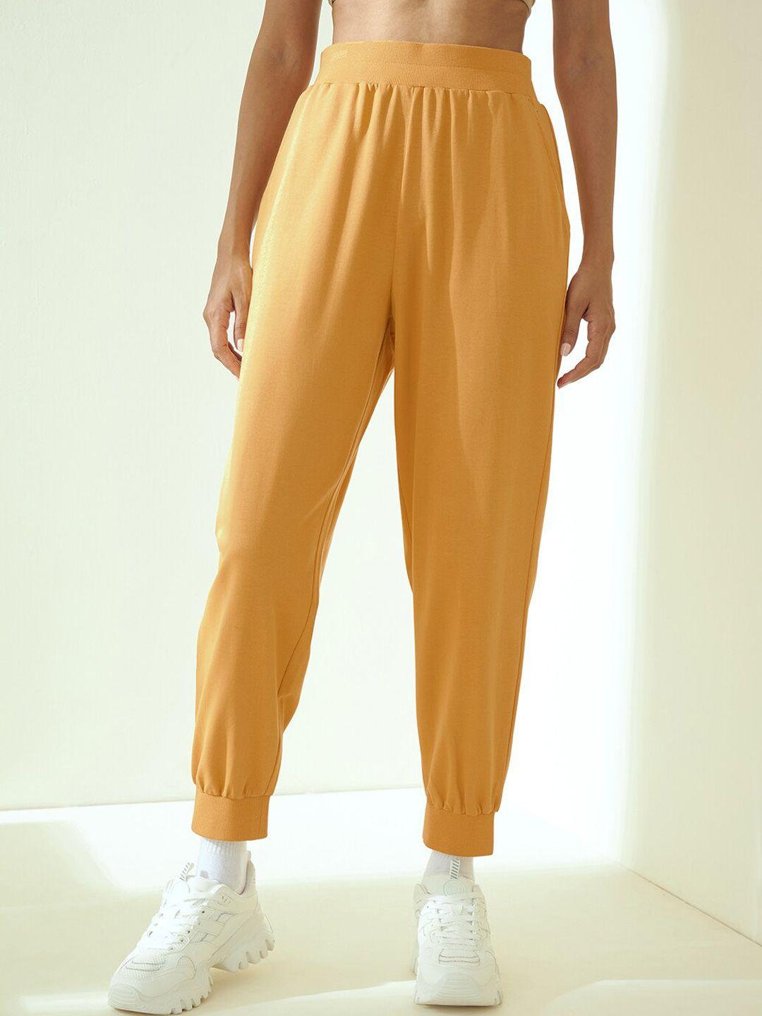 femella women yellow solid pure cotton joggers