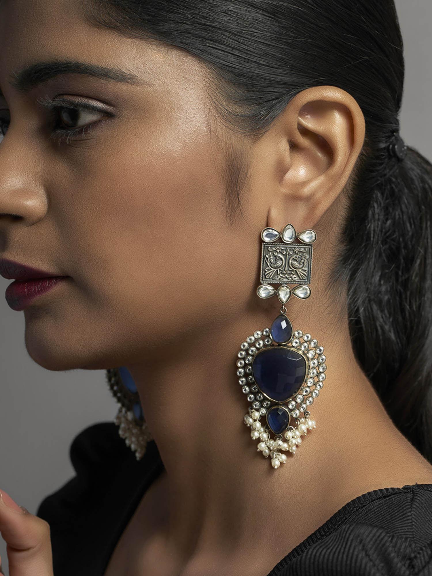 gentle waft blue sapphire statement earrings with deep nakshi design