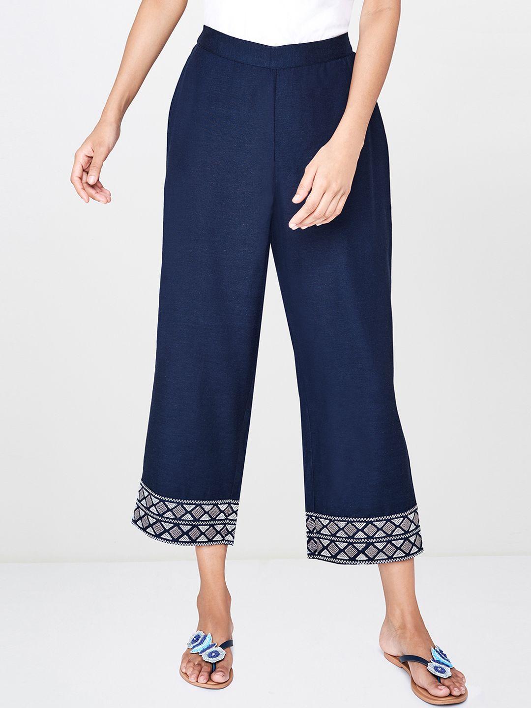 global desi women navy blue relaxed fit solid regular trousers with embroidered hem