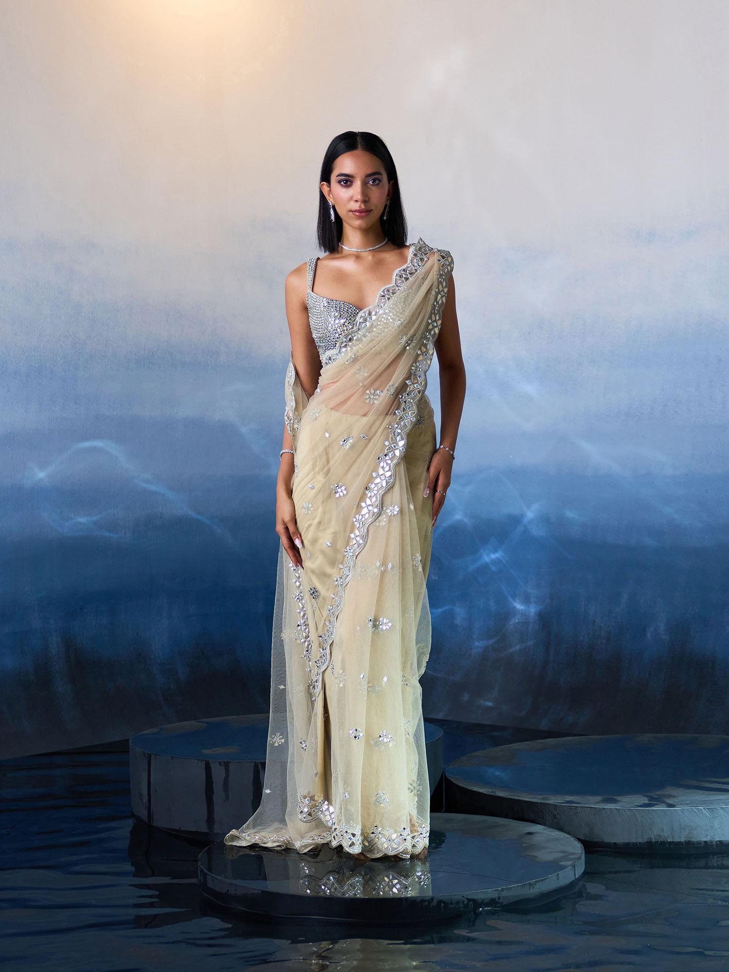 gold net saree with stitched blouse and petticoat