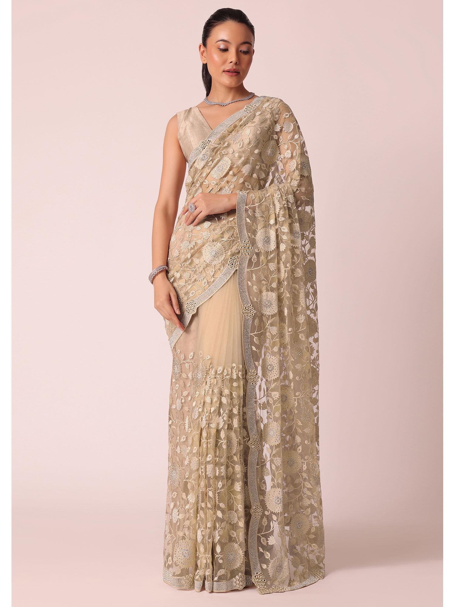 gold net saree with stone studded and floral work and unstitched blouse