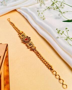 gold-plated bracelet with floral accent