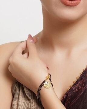 gold-plated mangalsutra bracelet with lobster claw closure