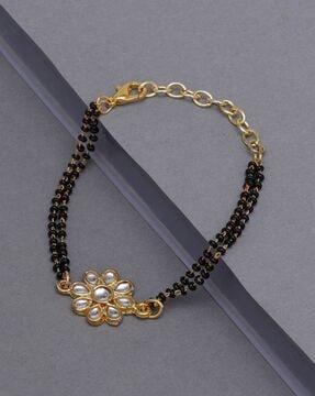 gold-plated mangalsutra bracelet with lobster claw closure